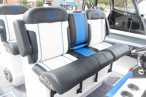 Slide: The Image of 2024 Fountain 34 SC boat seating with black, white, and blue upholstery. - 30