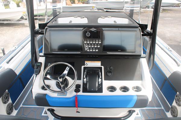 Slide: The Image of 2024 Fountain 34 SC boat dashboard with dual screens and steering wheel. - 32