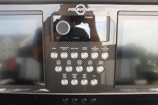Slide: The Image of Control panel of 2024 Fountain 34 SC boat with dual screens and buttons. - 38