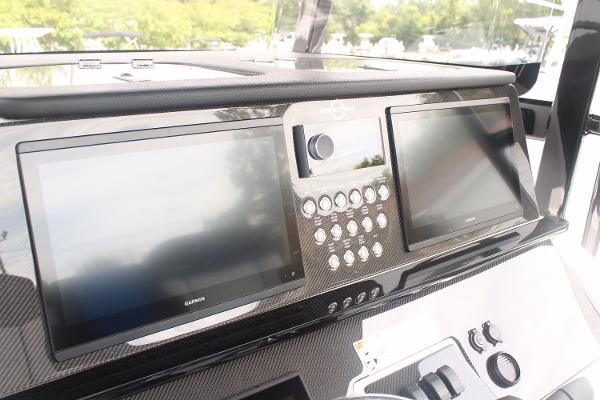 Slide: The Image of 2024 Fountain 34 SC boat dashboard with dual Garmin displays and control panel. - 39