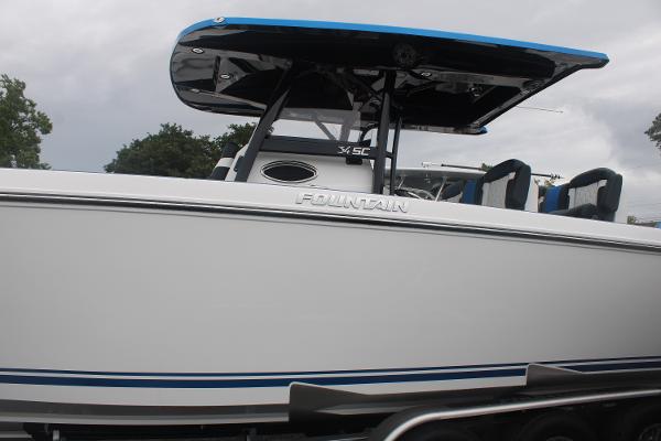 Slide: The Image of 2024 Fountain 34 SC boat with sleek white hull and blue accents. - 4