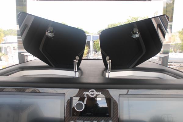 Slide: The Image of 2024 Fountain 34 SC boat dashboard with open storage compartments. - 40