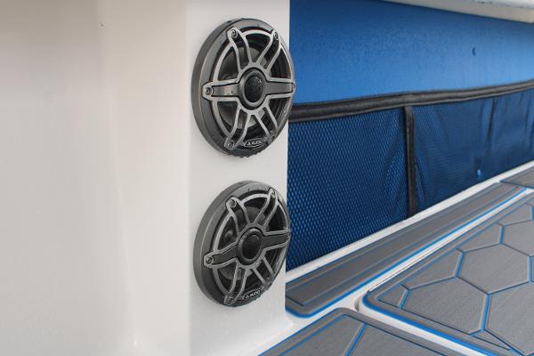 Slide: The Image of 2024 Fountain 34 SC boat interior with dual speakers and blue accents. - 43