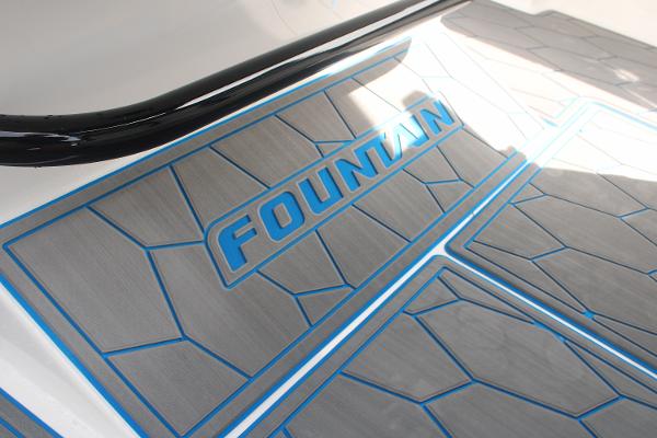 Slide: The Image of 2024 Fountain 34 SC boat deck with blue and gray geometric design. - 44