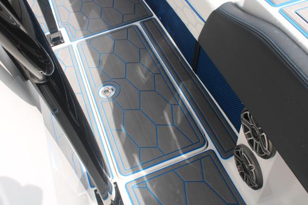 Slide: The Image of 2024 Fountain 34 SC boat deck with blue and gray geometric design. - 45