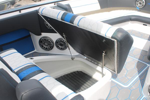 Slide: The Image of 2024 Fountain 34 SC boat interior with open storage compartment and speakers. - 47