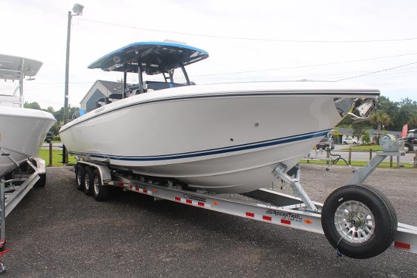 Slide: The Image of 2024 Fountain 34 SC boat on a trailer in a parking lot. - 5