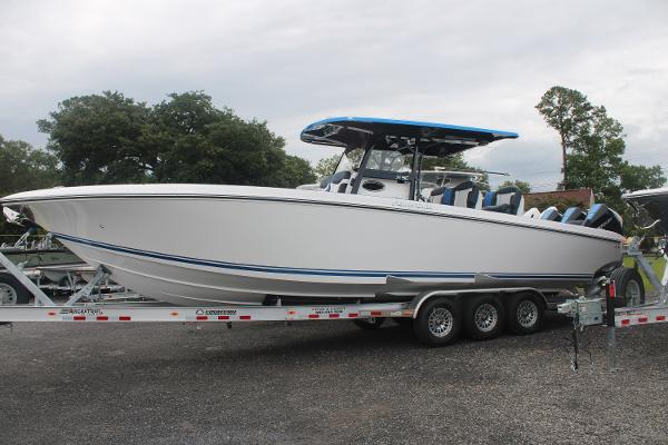 Slide: The Image of 2024 Fountain 34 SC boat on a triple-axle trailer, side view. - 6