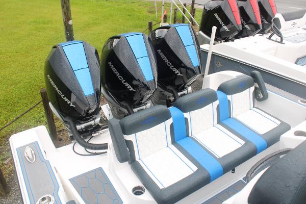 Slide: The Image of 2024 Fountain 34 SC boat with Mercury outboard engines and blue-accented seating. - 8