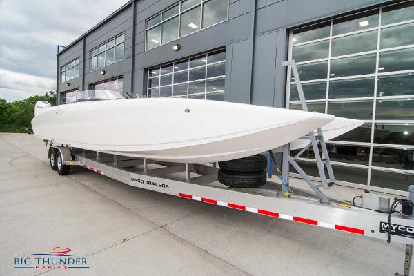 Slide: The Image of 2023 Fountain 34 Thunder Cat boat on Myco trailer outside Big Thunder Marine. - 2