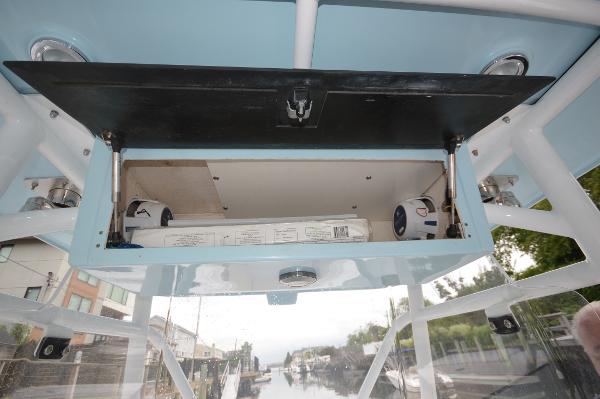 Slide: The Image of Open storage compartment on a 2017 Fountain 38 Center Console boat. - 13