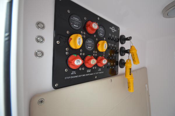 Slide: The Image of Control panel of a 2017 Fountain 38 Center Console boat with switches and safety keys. - 22
