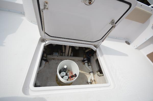 Slide: The Image of Open hatch of 2017 Fountain 38 Center Console boat showing storage compartment. - 25