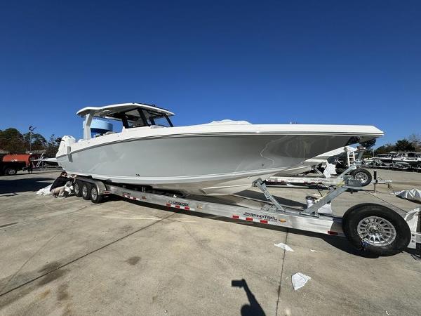 Slide: The Image of 2024 Fountain 38 SCX boat on a trailer in a marina. - 10