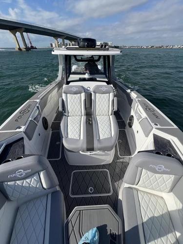 Slide: The Image of 2024 Fountain 38 SCX boat interior on the water with bridge in background. - 24