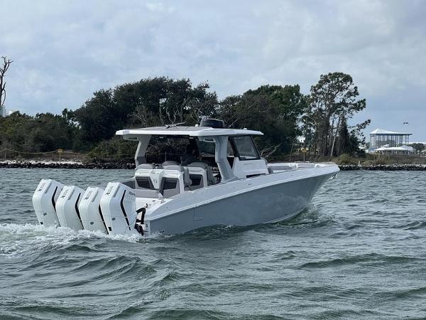 Slide: The Image of 2024 Fountain 38 SCX boat cruising on water with triple outboard engines. - 5