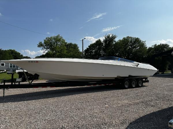 Slide: The Image of 2002 Fountain 42 Lightning speedboat on a trailer in a gravel lot. - 0