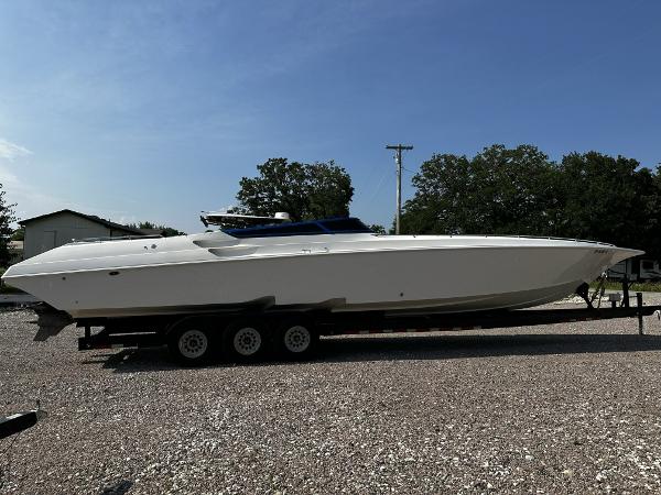 Slide: The Image of 2002 Fountain 42 Lightning speedboat on a trailer in a gravel lot. - 5