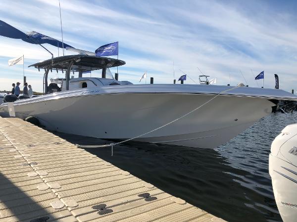 Slide: The Image of 2020 Fountain 43 NX boat docked at marina under clear sky. - 0