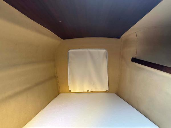 Slide: The Image of Interior cabin of 1998 Fountaine Pajot Athena 38 catamaran, featuring a cozy sleeping area. - 18