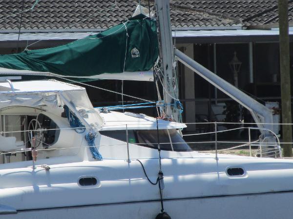Slide: The Image of 1998 Fountaine Pajot Athena 38 catamaran with green sail cover docked. - 23