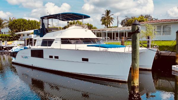 Slide: The Image of 2015 Fountaine Pajot Cumberland 47 LC yacht docked in a serene marina setting. - 10