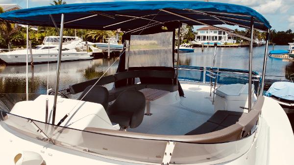 Slide: The Image of 2015 Fountaine Pajot Cumberland 47 LC yacht with spacious deck and canopy in marina. - 12