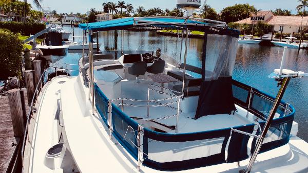 Slide: The Image of 2015 Fountaine Pajot Cumberland 47 LC yacht docked in a serene marina setting. - 14