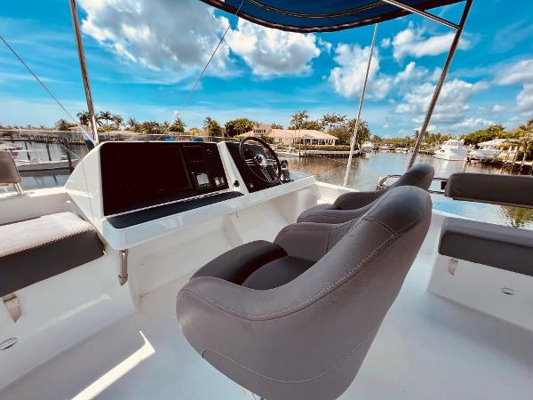 Slide: The Image of Fountaine Pajot Cumberland 47 LC 2015 yacht helm with scenic waterfront view. - 18