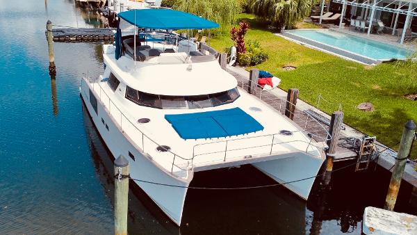 Slide: The Image of 2015 Fountaine Pajot Cumberland 47 LC catamaran docked by a poolside. - 4