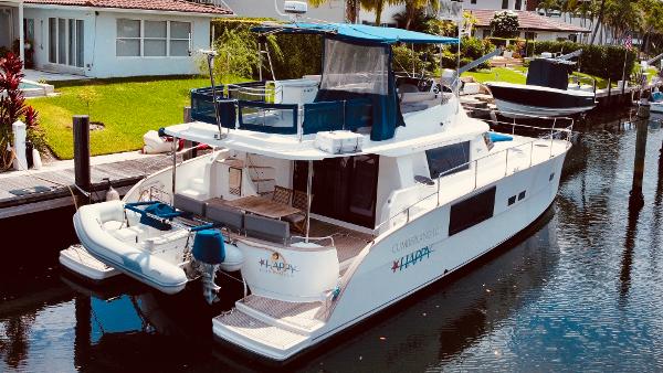 Slide: The Image of 2015 Fountaine Pajot Cumberland 47 LC yacht docked in a serene canal setting. - 9