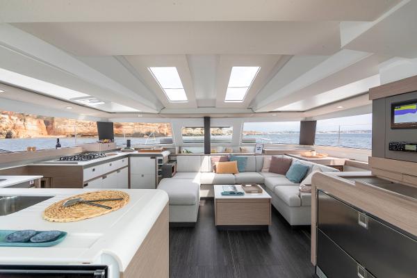 Slide: The Image of Luxurious interior of 2024 Fountaine Pajot Elba 45 catamaran with modern furnishings and panoramic windows. - 10