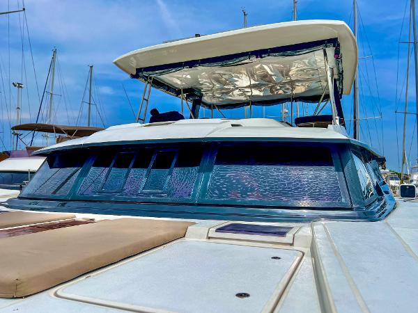 Slide: The Image of 2017 Fountaine Pajot Ipanema 58 Power Catamaran docked, showcasing its sleek design and spacious deck. - 16