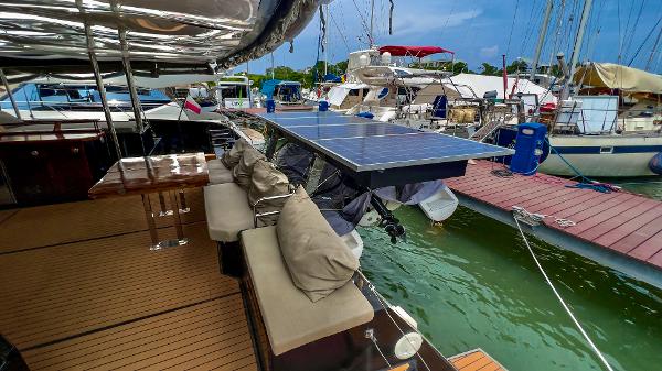 Slide: The Image of 2017 Fountaine Pajot Ipanema 58 Power Catamaran docked, featuring solar panels and cushioned seating. - 32