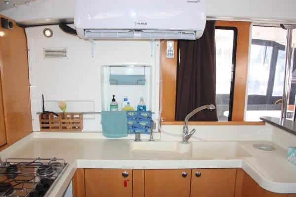 Slide: The Image of 2008 Fountaine Pajot Orana 44 catamaran kitchen with sink, stove, and storage. - 24