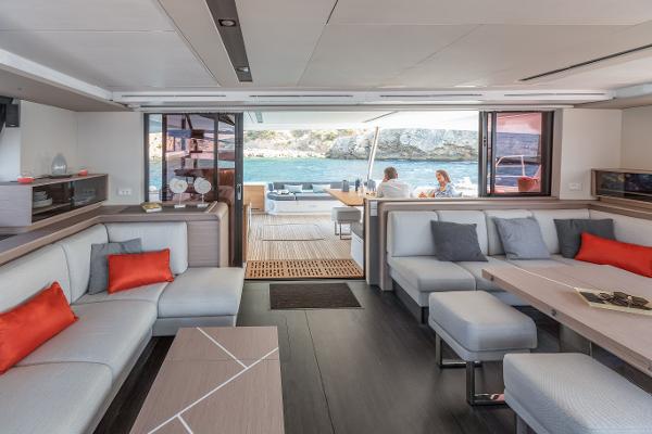 Slide: The Image of Luxurious interior of 2024 Fountaine Pajot Samana 59 yacht with modern seating and ocean view. - 12