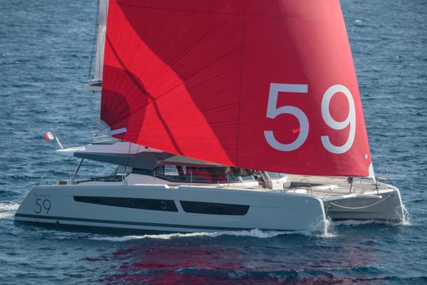 Slide: The Image of 2024 Fountaine Pajot Samana 59 catamaran with red sails on the open sea. - 15