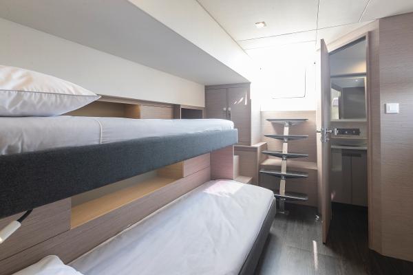 Slide: The Image of 2024 Fountaine Pajot Samana 59 interior cabin with bunk beds and modern design. - 9
