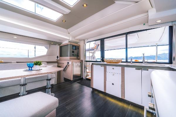 Slide: The Image of Modern interior of 2024 Fountaine Pajot Tanna 47 catamaran with dining and kitchen area. - 18