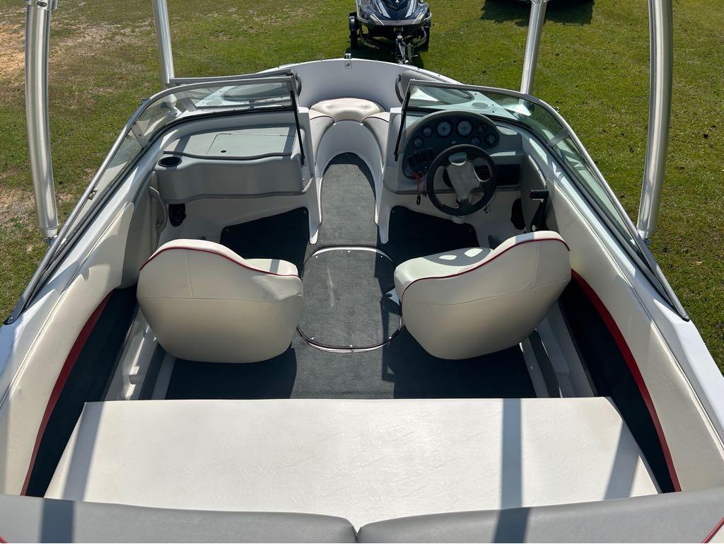 Slide: The Image of Interior of a 2000 Four Winns Horizon 170 boat with white seating and dashboard. - 2