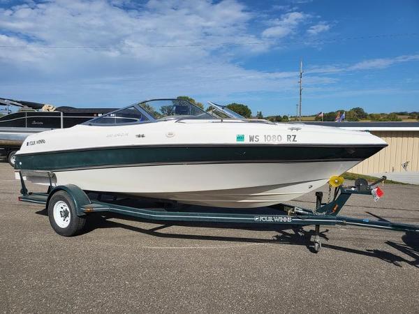 Slide: The Image of 1998 Four Winns 200 Horizon boat on trailer under clear blue sky. - 1