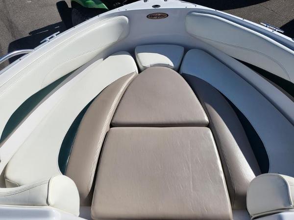 Slide: The Image of 1998 Four Winns 200 Horizon boat interior with cushioned seating. - 10