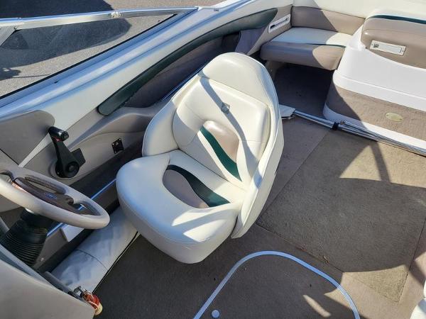 Slide: The Image of 1998 Four Winns 200 Horizon boat interior with white seating and steering wheel. - 11