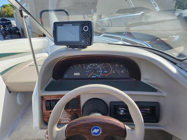 Slide: The Image of Dashboard of 1998 Four Winns 200 Horizon boat with steering wheel and navigation system. - 12