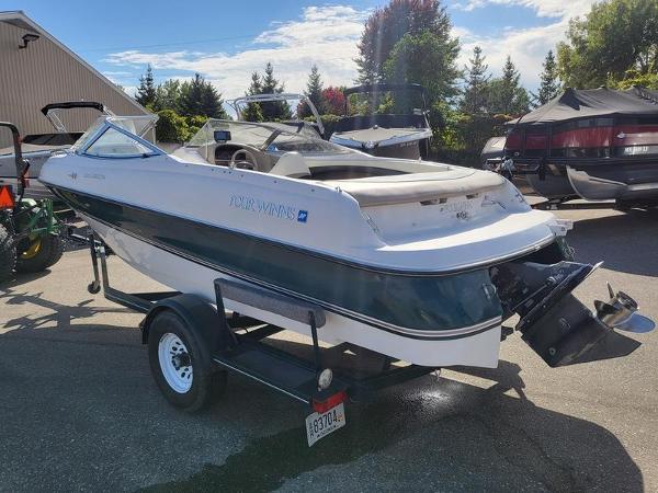 Slide: The Image of 1998 Four Winns 200 Horizon boat on trailer, parked outdoors under clear sky. - 5