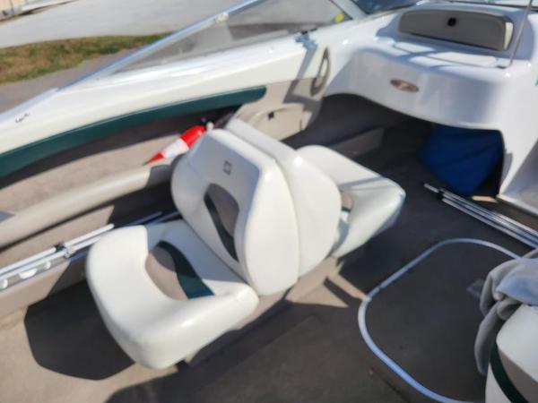 Slide: The Image of 1998 Four Winns 200 Horizon boat interior with white seating and dashboard. - 9