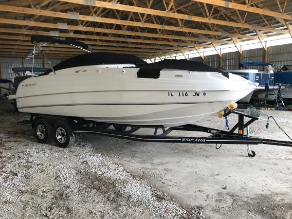 Slide: The Image of 2004 Four Winns 234 Funship boat on trailer in covered storage. - 0