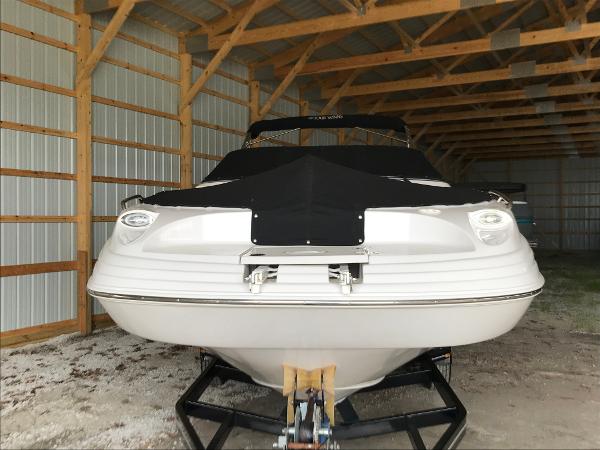 Slide: The Image of 2004 Four Winns 234 Funship boat stored in a wooden shed. - 1