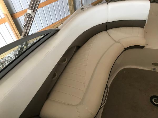 Slide: The Image of 2004 Four Winns 234 Funship boat interior with beige seating and cup holders. - 11