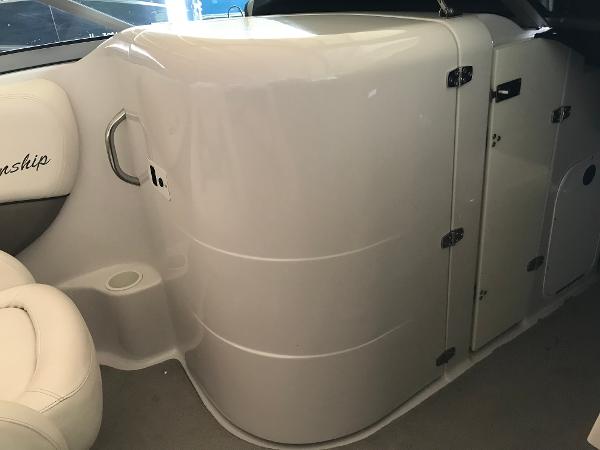 Slide: The Image of 2004 Four Winns 234 Funship boat interior with white seating and storage compartment. - 13